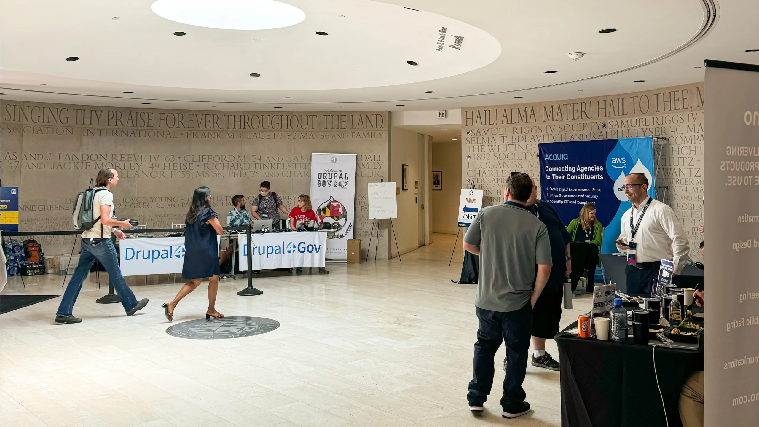 People walking through registration at Drupal GovCon 2024