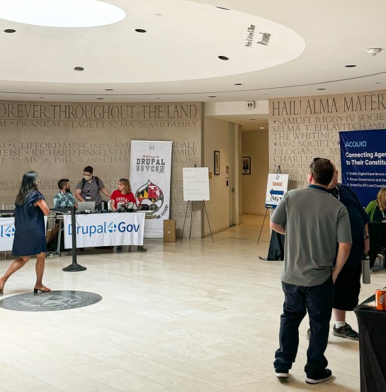 People walking through registration at Drupal GovCon 2024